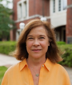 Woman looking authorly with brick buildings in background