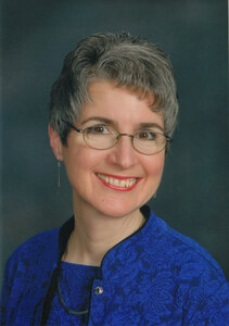 Color photo Carmela Martino wearing a blue top and matching sweater