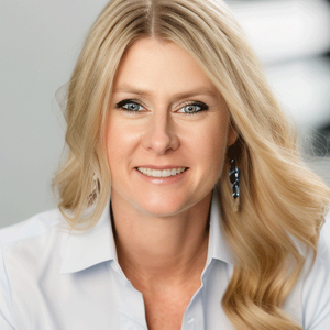 Photo of Dr. Rebbeca Lahann in a white button up shirt smiling straight ahead.