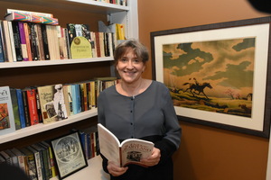 Photo of woman in front of bookshelf