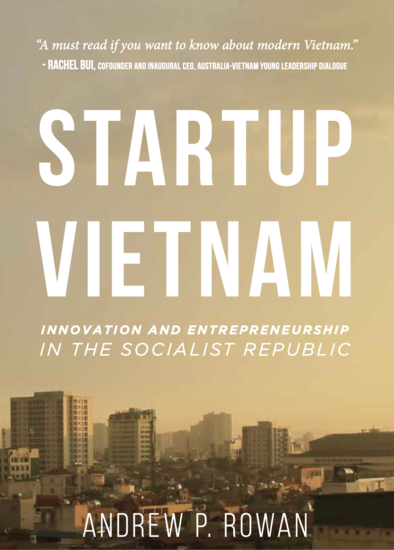 The cover of Startup Vietnam: Innovation and Entrepreneurship in the Socialist Republic by Andrew P. Rowan. The title is in bold white letters against a hazy golden skyline of Hanoi, Vietnam, with high-rise buildings in the background. A quote at the top 