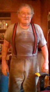 Up from beneath the floor, doing plumbing.