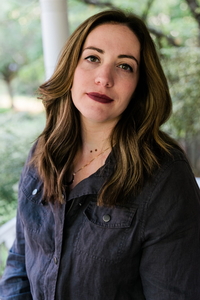 woman with dark hair, smiling at camera