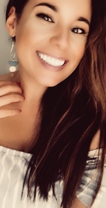 Long haired, brown woman, smiling widely