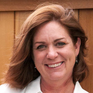 Smiling woman with medium length brown hair.
