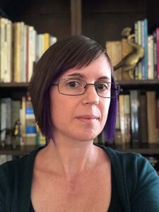white woman with short dark hair and glasses