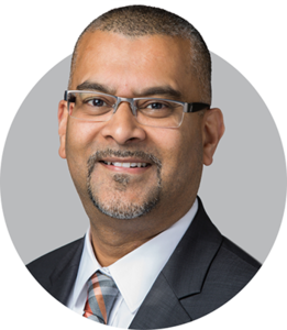 <img src="profile.png" alt="Faisal Kutty, a law professor, writer, and lawyer, wearing glasses and a suit, smiling at the camera." />