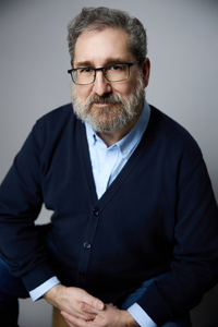 A fair-skinned, middle-aged man with short, graying brown hair and a full beard.