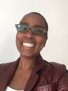 Headshot of Michelle Mellon smiling wearing crimson jacket