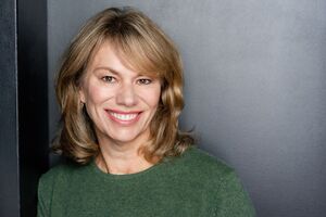 photo of smiling woman in green sweater