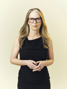 Photo of Michelle Maryk wearing glasses in a black sleeveless dress