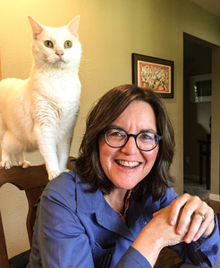 Woman with white cat on her shoulder