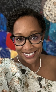 Photo of Sidney Logan Echevarria, an African-American woman who wears glasses