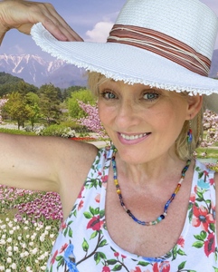 Woman wearing a straw hat while standing in a garden
