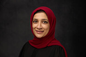 smiling south asian woman in a red hijab