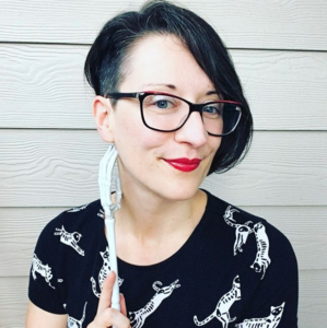Photo of the author holding a plastic skeleton hand