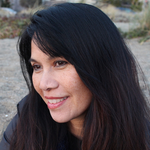 three quarter view of black haired female smiling