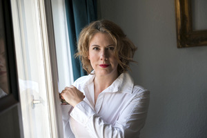 Nina George, standing at a window