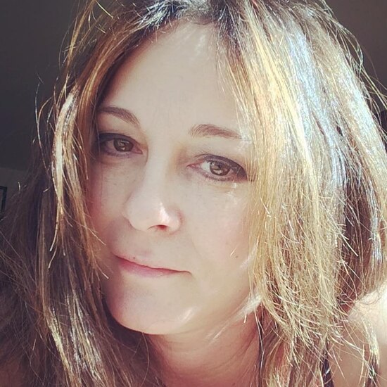 headshot sized photo of the author, a white woman in her early 50s with long light brown hair