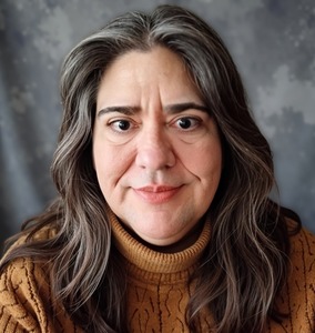 Headshot of poetess Karen Schnurstein, a middle-aged Caucasian woman with dark hair and eyes and large glasses.
