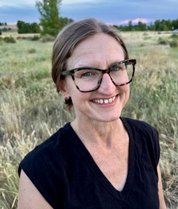 Woman with glasses outdoors.