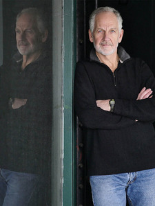 alt=bearded man with arms crossed 