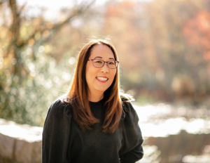 Debbi Michiko Florence in front of a pond