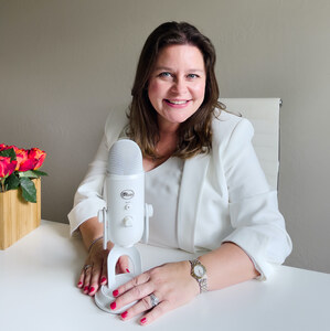 Michelle Glogovac at desk with podcast microphone