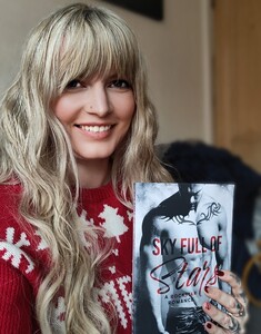 Woman holding book smiling