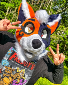 Alex Frey wearing a orange and blue dog costume.
