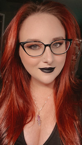 Picture of C.N.Maxwell, a woman with bright red hair and black glasses