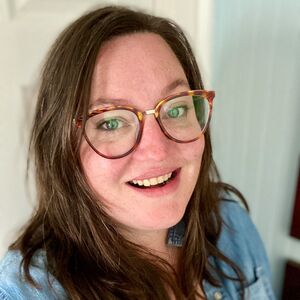 Alyssa Bones headshot, a white woman with dark brown hair and glasses