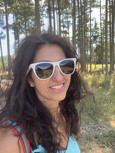Woman wearing white glasses hiking in Forrest 