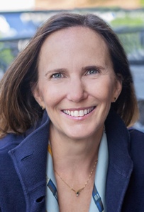 Close-up photo of author sitting outside at cafe table.