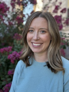 Photo of a woman smiling and looking at the camera
