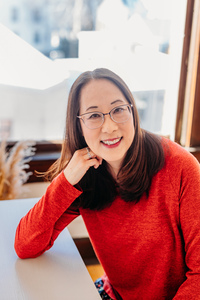Debbi Michiko Florence at a desk