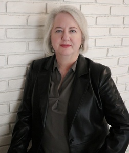Author photo with brick wall background