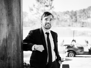 This is a headshot of Will Carter, black and white, in a suit.