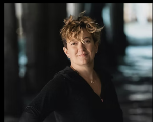 author standing in front of ocean