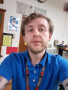 Profile photo of MN Bennet in a blue dress shirt. Brownish blond hair and blue eyes.