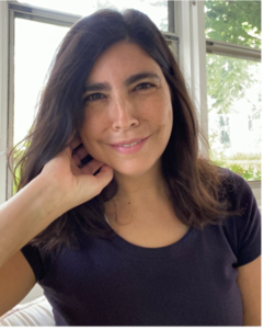 Photo of woman with black hair leaning her chin on her hand