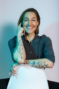 Profile shot of author sitting on a chair