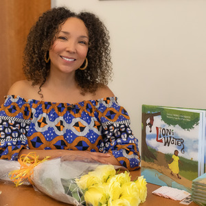 Sheila Hackbarth in front of her picture book Lion's Water
