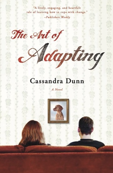 A man and woman sit on a couch, facing away from the viewer