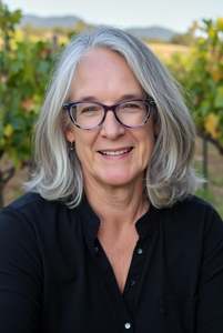 Children's book author Dawn Dolan smiling in a vineyard shot