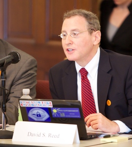 Photo of David S. Reed speaking at a meeting.