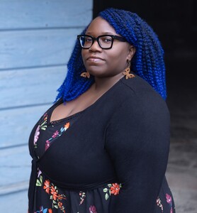 brown women with glasses and blue hair