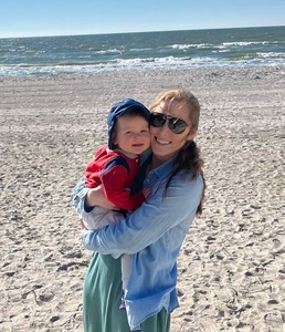 Picture of Emily and son Julian on a beach