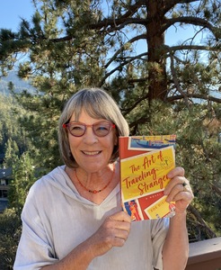 Photo of Zoe Disigny with novel THE ART OF TRAVELING STRANGERS 