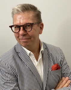 Charles in a checked jacket and a smile